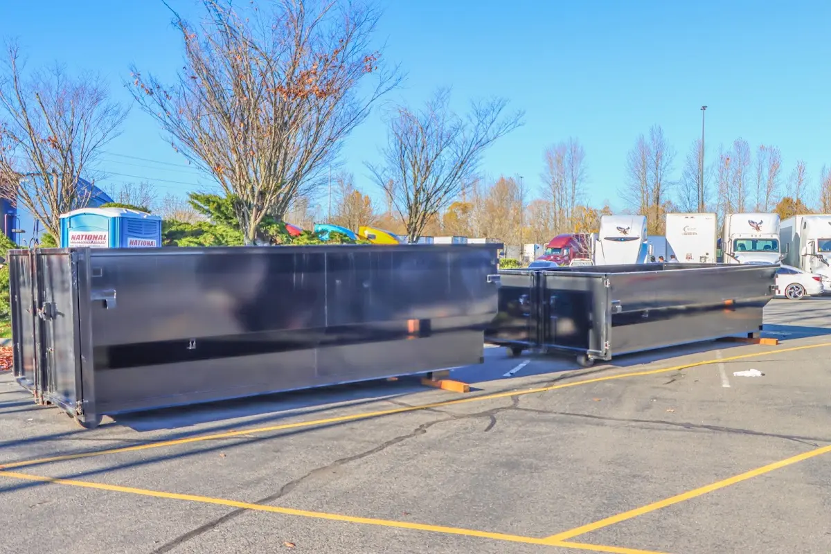 Professional dumpster rental service with roll-off container on residential driveway in Cohasset